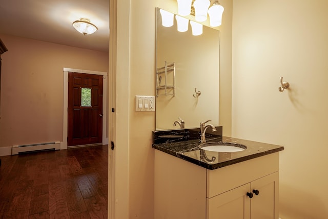 bathroom with a baseboard radiator, vanity, and wood finished floors