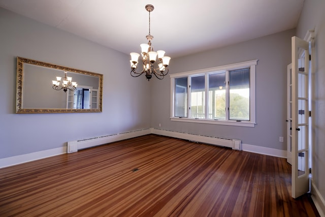 empty room with baseboards, a notable chandelier, wood finished floors, and a baseboard heating unit