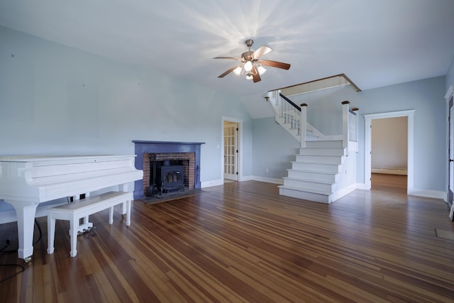 unfurnished living room featuring baseboards, ceiling fan, wood finished floors, stairs, and a baseboard heating unit