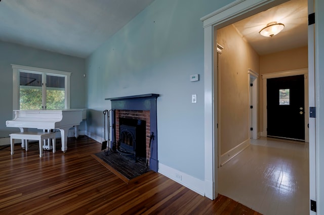 unfurnished living room featuring dark hardwood / wood-style floors and a fireplace