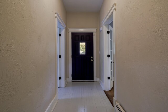 entryway with baseboards and wood finished floors
