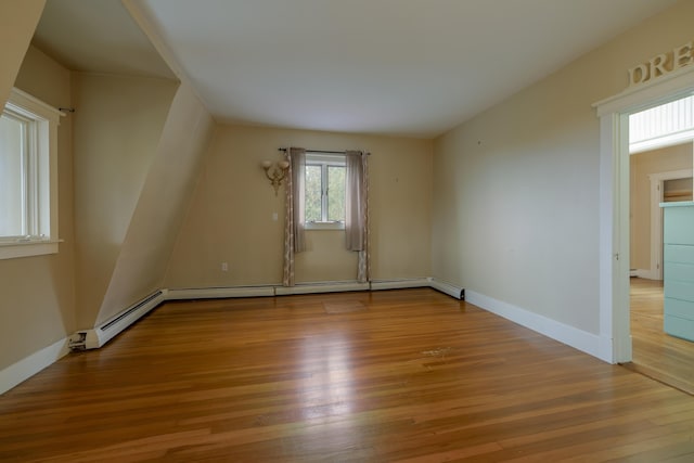 empty room featuring baseboards and wood finished floors