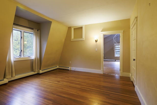 spare room with baseboards, a baseboard radiator, and hardwood / wood-style floors