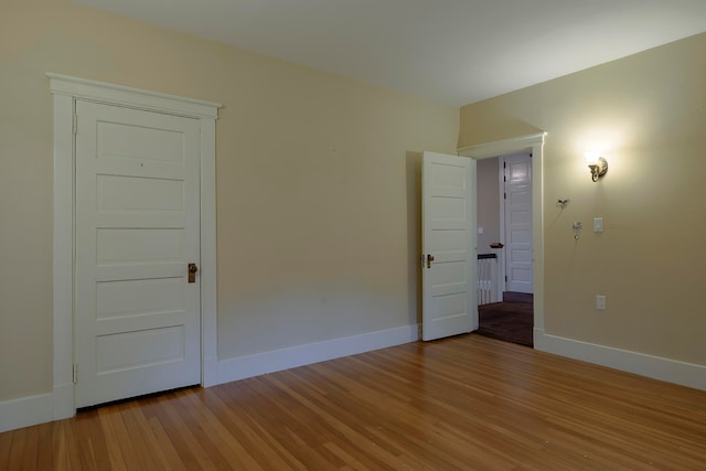 unfurnished bedroom with hardwood / wood-style flooring