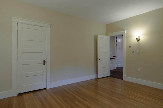spare room featuring light wood finished floors and baseboards