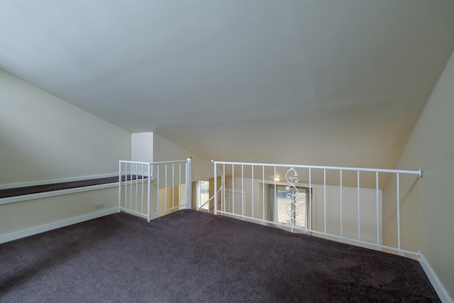 additional living space featuring baseboards, lofted ceiling, and carpet