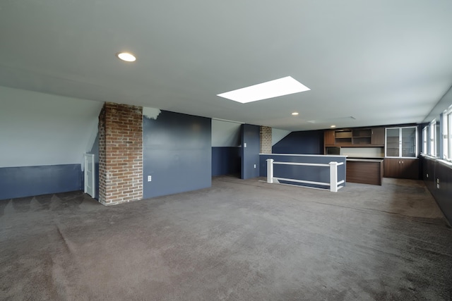 unfurnished living room featuring recessed lighting, carpet flooring, and a skylight
