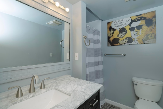 bathroom featuring walk in shower, vanity, and toilet