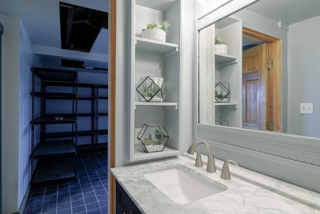 bathroom with tile patterned flooring and vanity