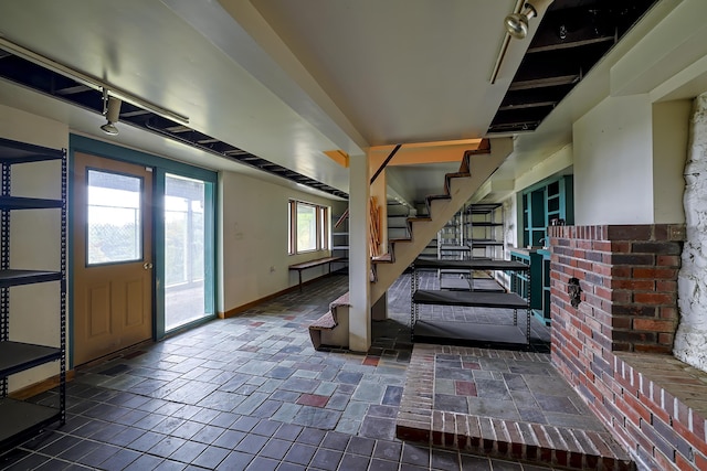 foyer entrance with baseboards and stairway