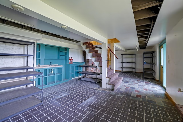 below grade area with stairs and baseboards