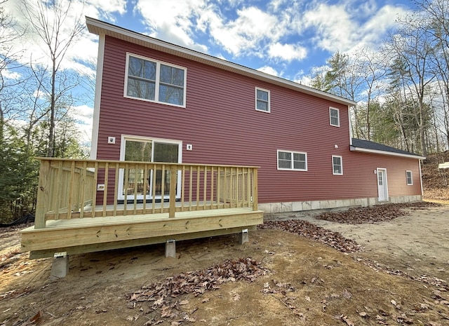 rear view of house featuring a wooden deck