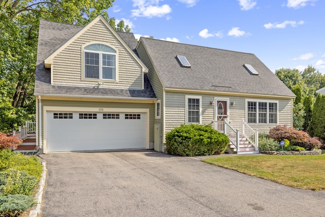 new england style home featuring a garage and a front lawn