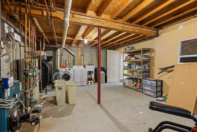 unfinished basement featuring heating fuel and separate washer and dryer