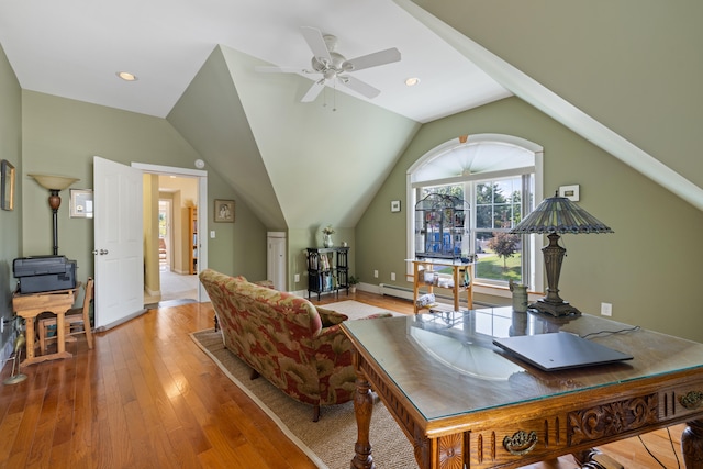 office featuring baseboards, a baseboard heating unit, vaulted ceiling, and wood finished floors