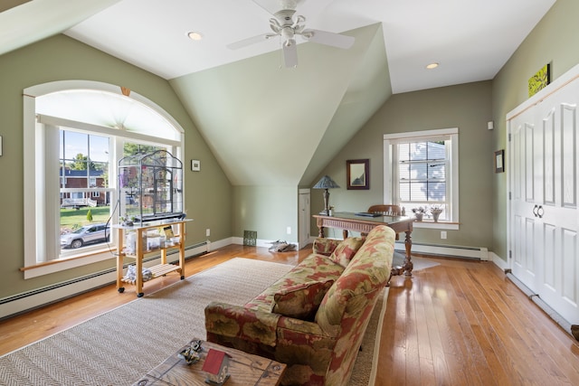 living room featuring light wood-style floors, a baseboard radiator, and plenty of natural light