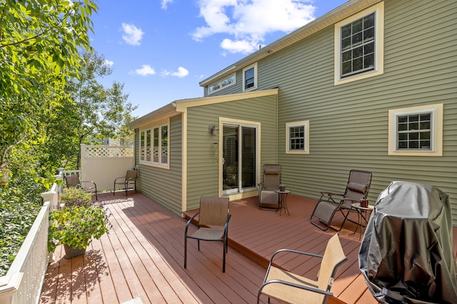 wooden terrace featuring fence