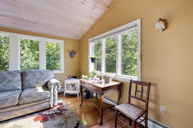 interior space with vaulted ceiling, a baseboard heating unit, wood ceiling, and a wealth of natural light