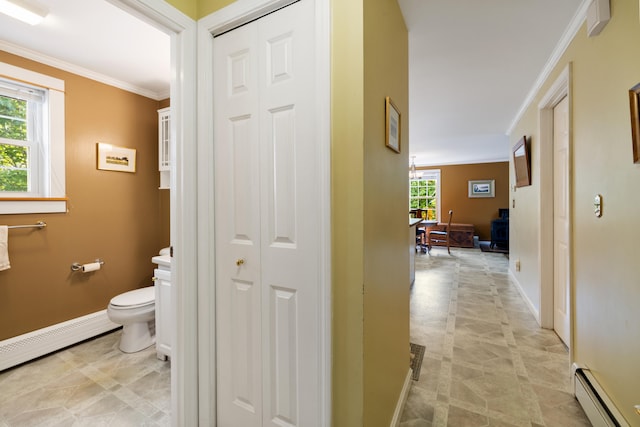 corridor featuring baseboards, baseboard heating, and crown molding