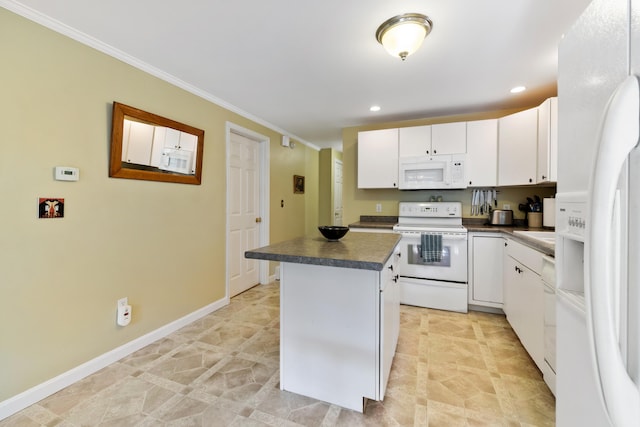 kitchen with a center island, dark countertops, white cabinets, white appliances, and baseboards