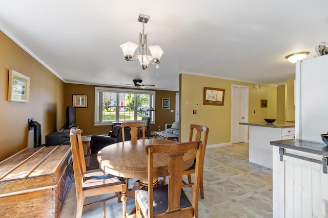 dining space featuring ceiling fan with notable chandelier, ornamental molding, and baseboards