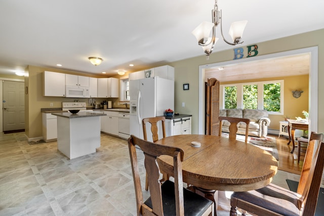 dining area with baseboards, a chandelier, and recessed lighting