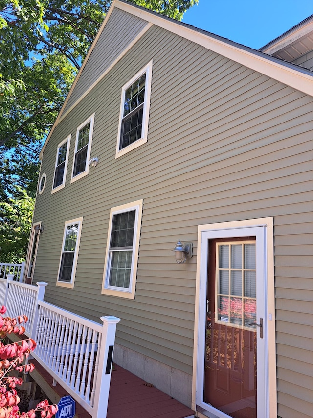 back of property with a wooden deck