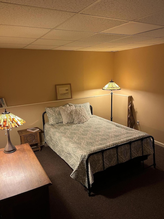 carpeted bedroom with a drop ceiling