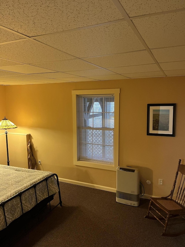 bedroom featuring carpet flooring, a paneled ceiling, and baseboards