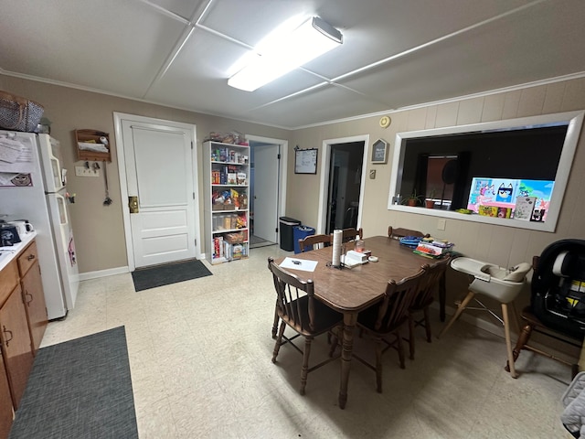 dining space featuring crown molding