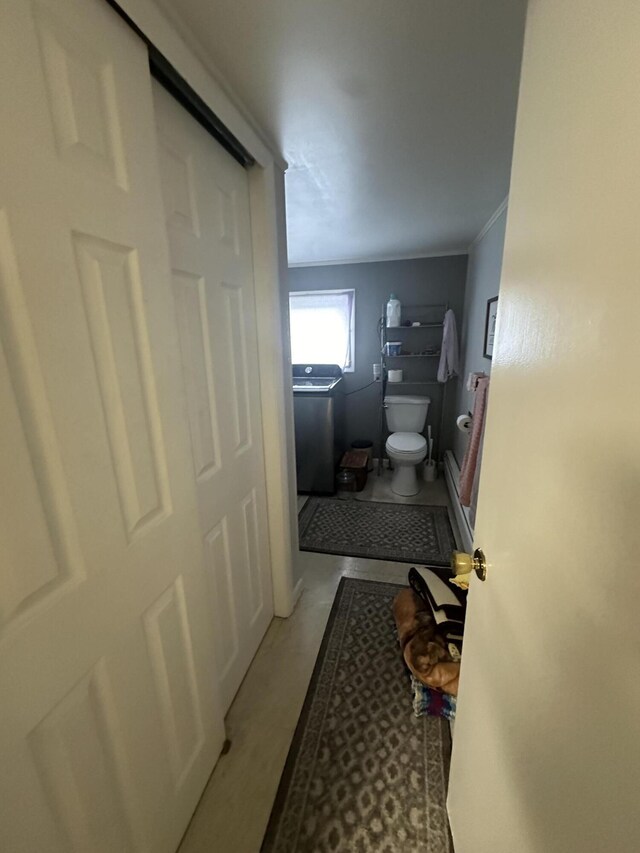 bathroom with ornamental molding, toilet, and tile patterned floors