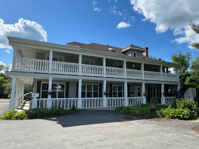 view of front of house with a balcony and a porch