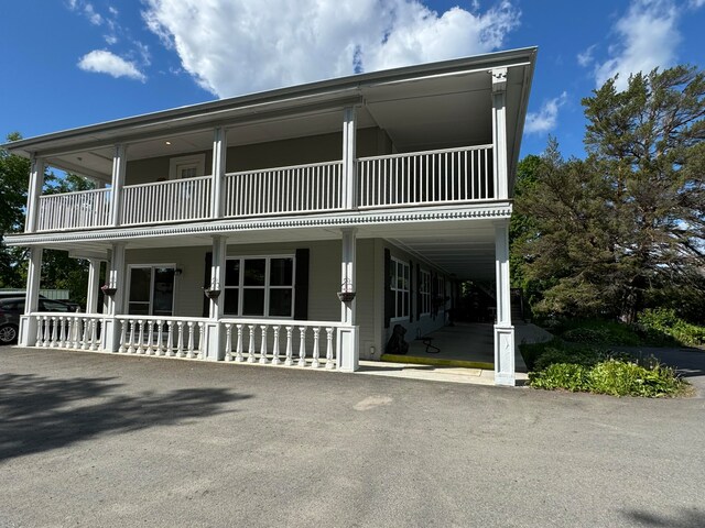 view of front of house with a balcony and a porch