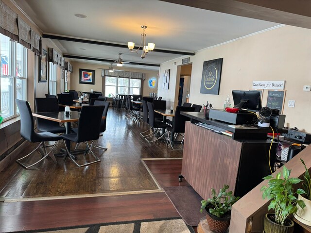 interior space with a notable chandelier, dark hardwood / wood-style floors, and ornamental molding