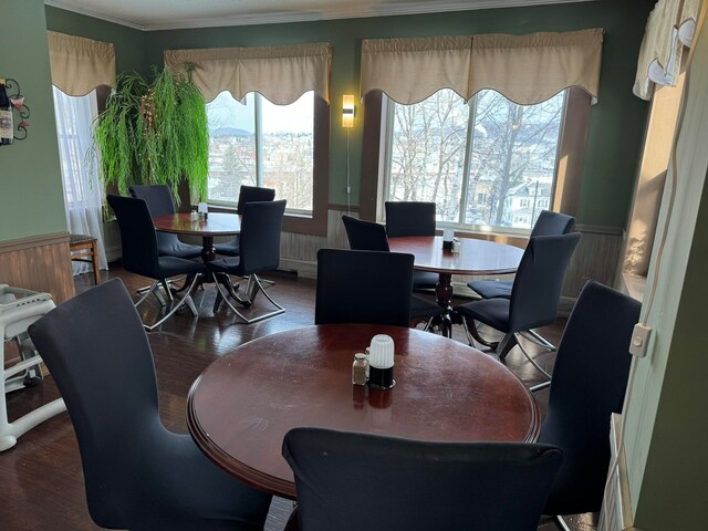 dining area with dark hardwood / wood-style floors and crown molding