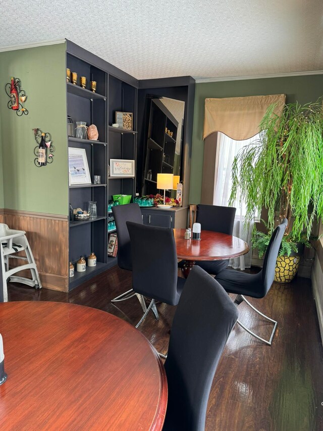 office area with a textured ceiling, dark wood-type flooring, and crown molding