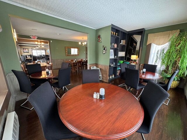 dining room featuring a textured ceiling, dark hardwood / wood-style floors, a chandelier, and plenty of natural light