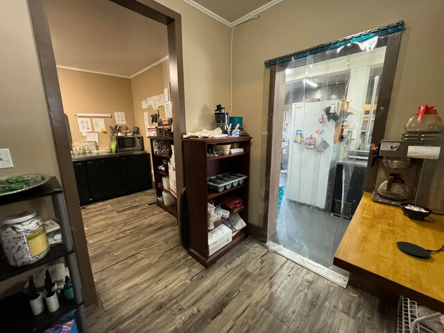 interior space featuring crown molding and hardwood / wood-style floors