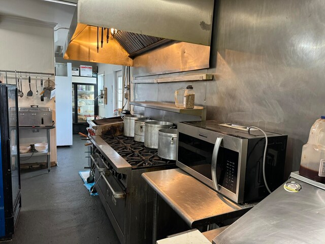 kitchen with appliances with stainless steel finishes and lofted ceiling