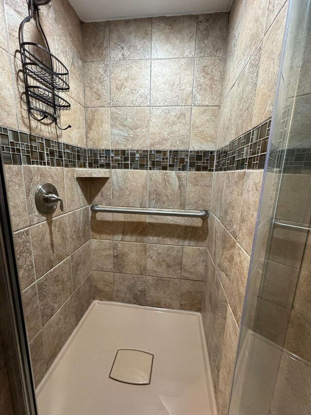 bathroom with a tile shower