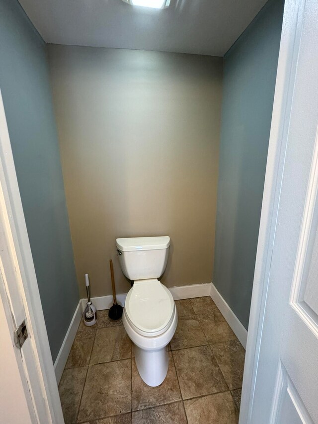 bathroom featuring tile patterned flooring and toilet