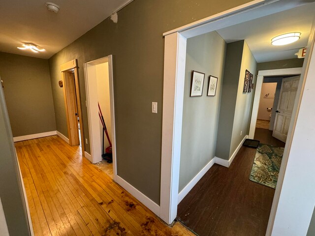 hallway with hardwood / wood-style flooring