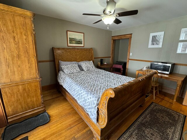 bedroom featuring ceiling fan and light hardwood / wood-style flooring