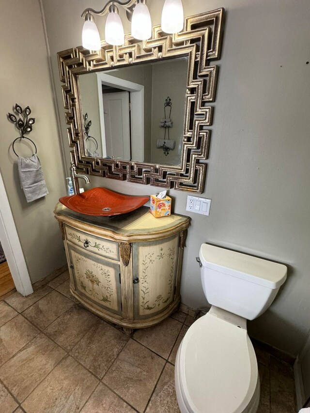 bathroom with tile patterned flooring, vanity, and toilet