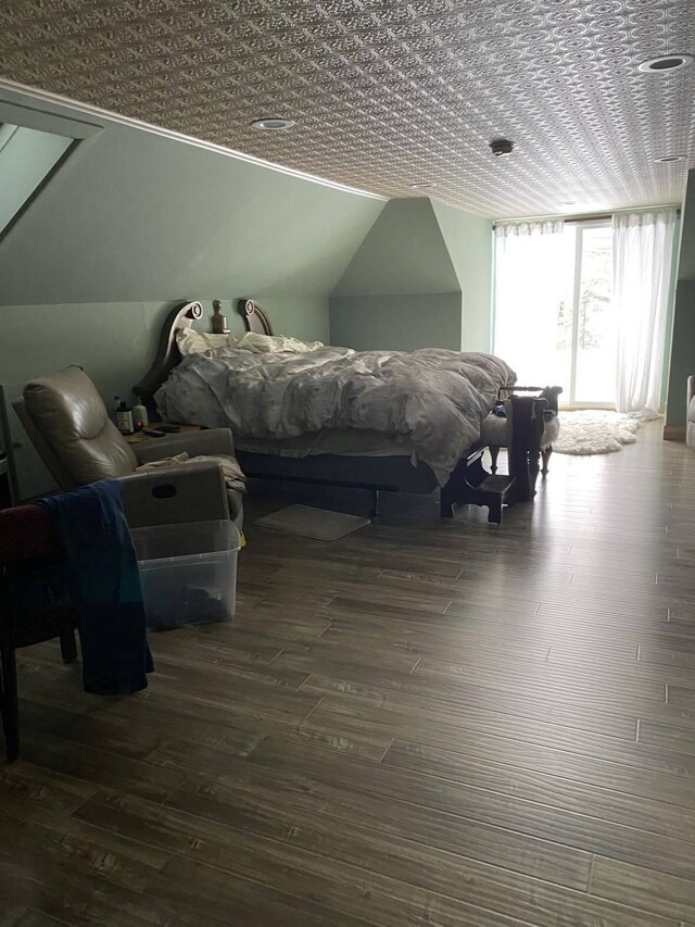 bedroom featuring lofted ceiling and dark wood-type flooring