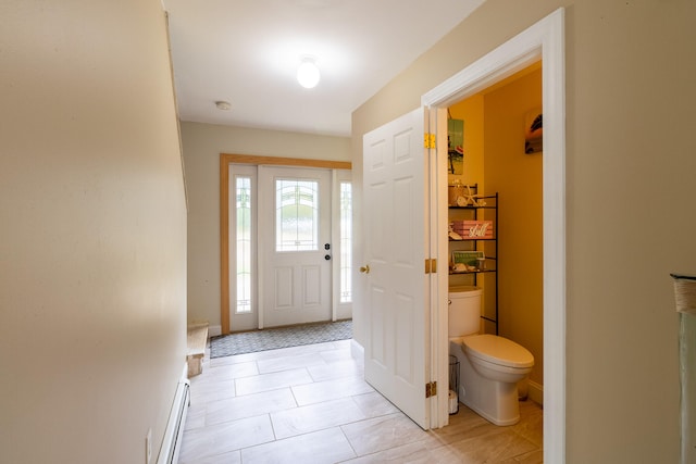 foyer with light tile patterned floors and a baseboard radiator