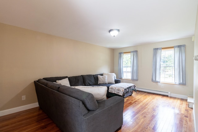 living room featuring a baseboard heating unit and wood-type flooring