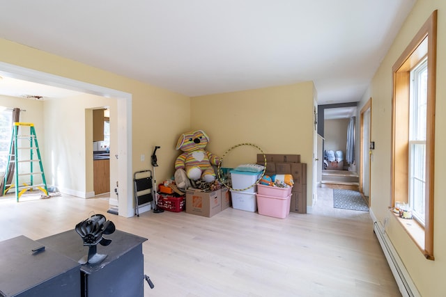 miscellaneous room featuring plenty of natural light, hardwood / wood-style floors, and a baseboard radiator