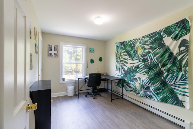 office with a baseboard heating unit and hardwood / wood-style flooring