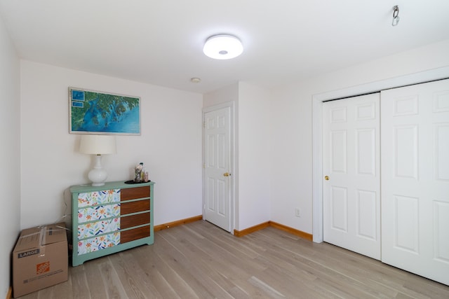 bedroom featuring light hardwood / wood-style flooring and a closet